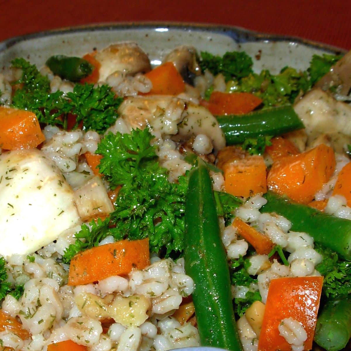 French barley salad with carrots, green beans, new potatoes and parsley.