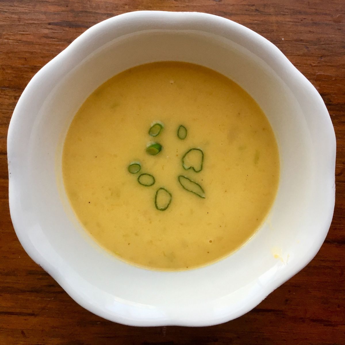Vichyssoise Soup in a pretty scalloped white bowl. 