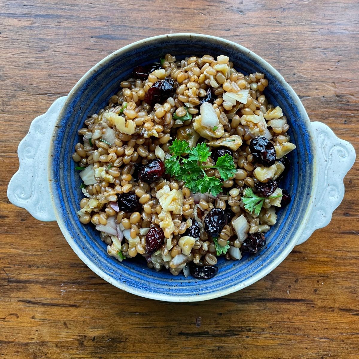 Winter wheatberry salad in a beautiful blue bowl.  