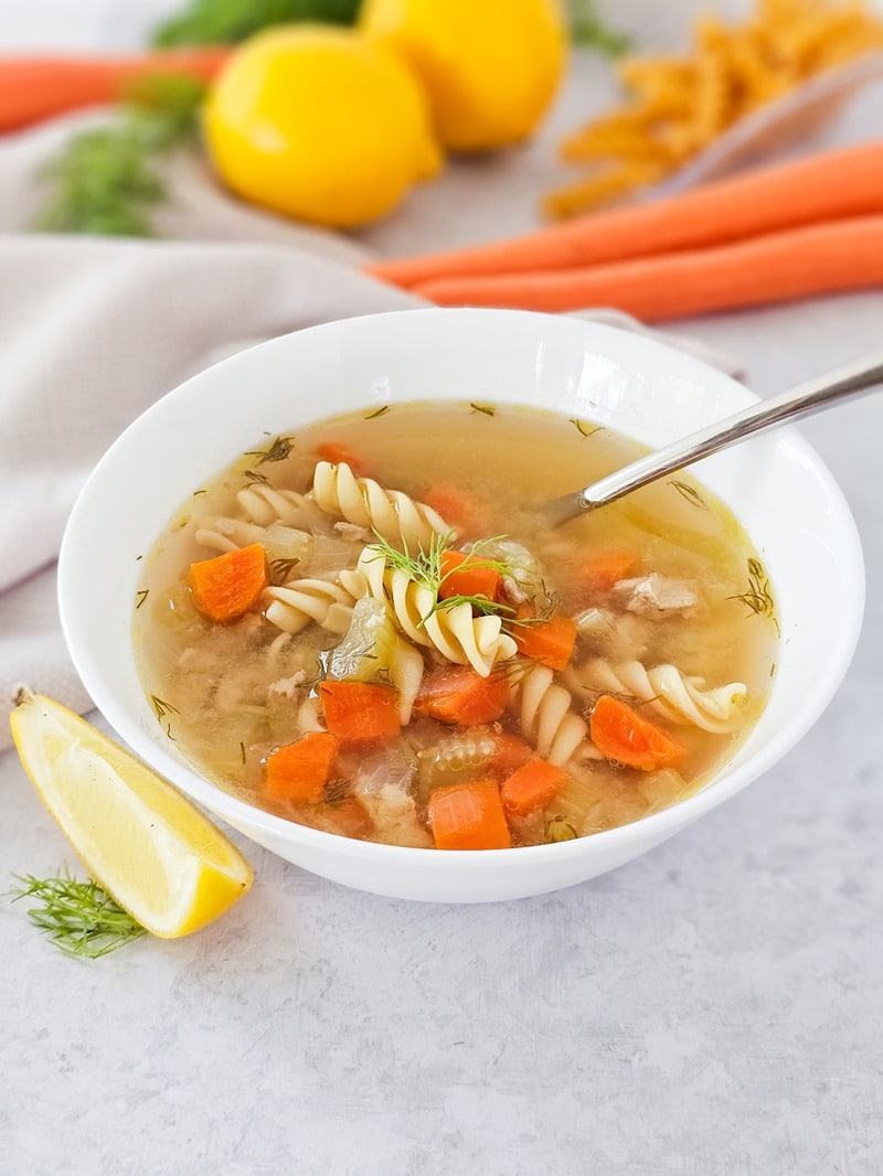 hot homemade chicken soup with noodles and ground chicken