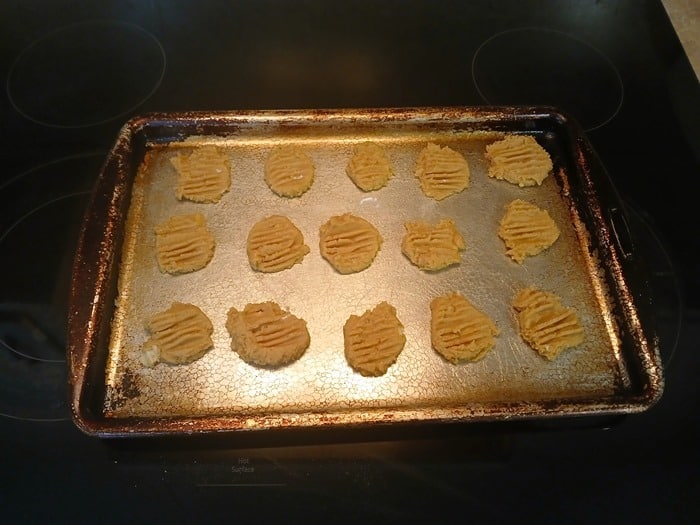 peanut butter cookie dough on a cookie sheet