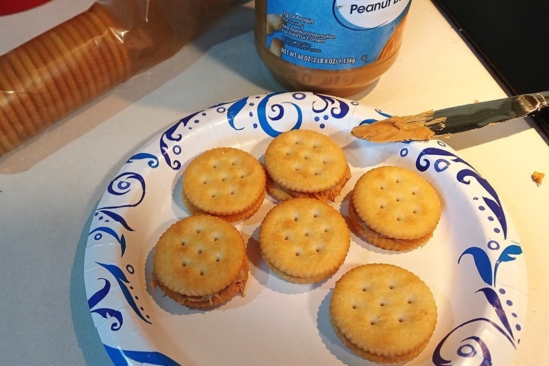 making dipped Ritz and peanut butter crackers