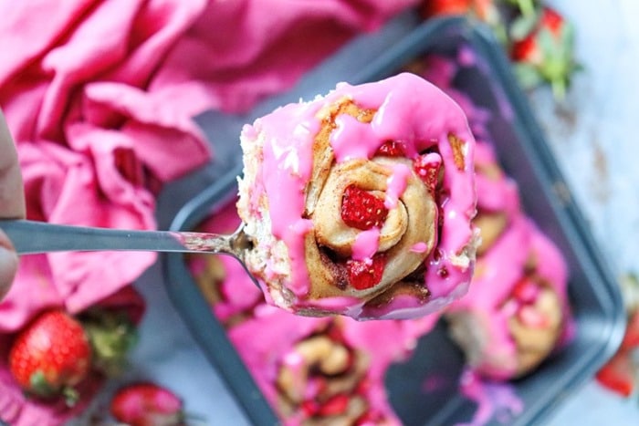 make sweet Valentine cinnamon rolls with pink icing and strawberries