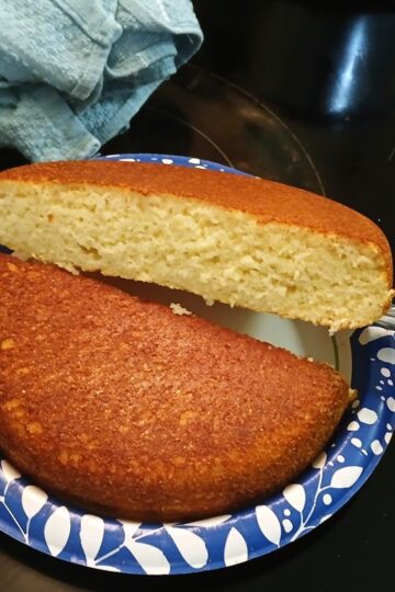 Iron Skillet cornbread made with buttermilk, corn meal mix, hot bacon grease, and egg, baking soda, and salt.