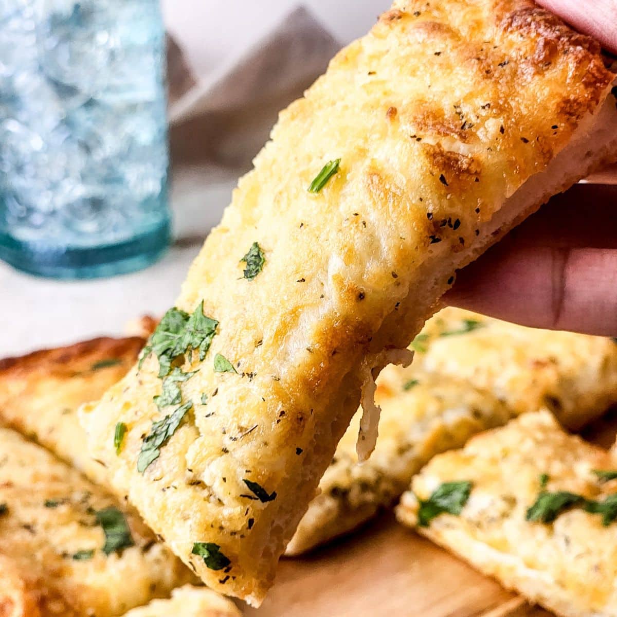 close up of cheesy breadsticks