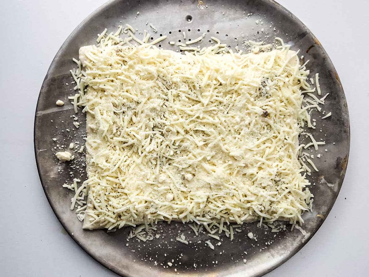 basil, oregano, and salt on top of the cheeses. 
