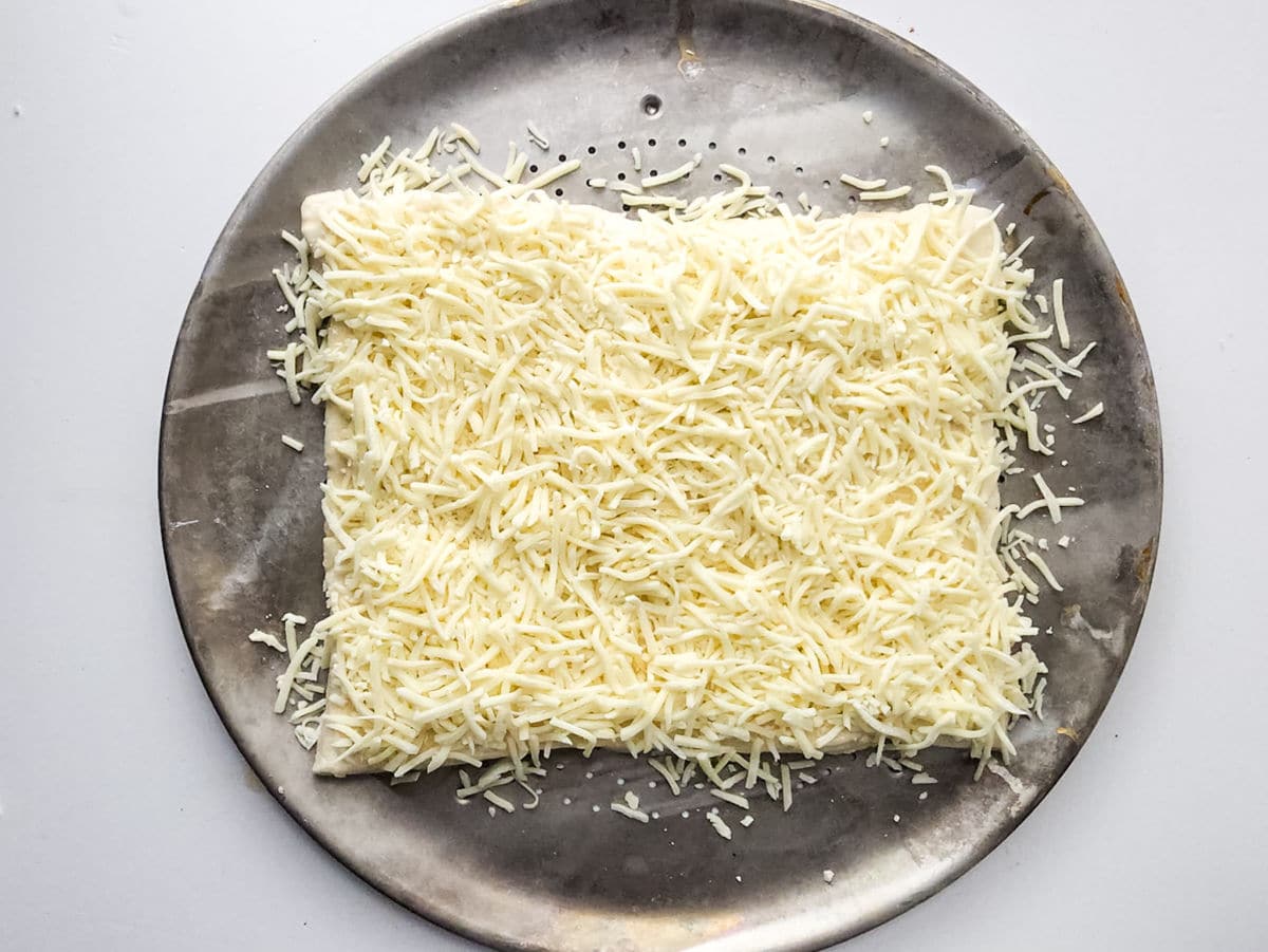 mozzarella cheese on pizza dough