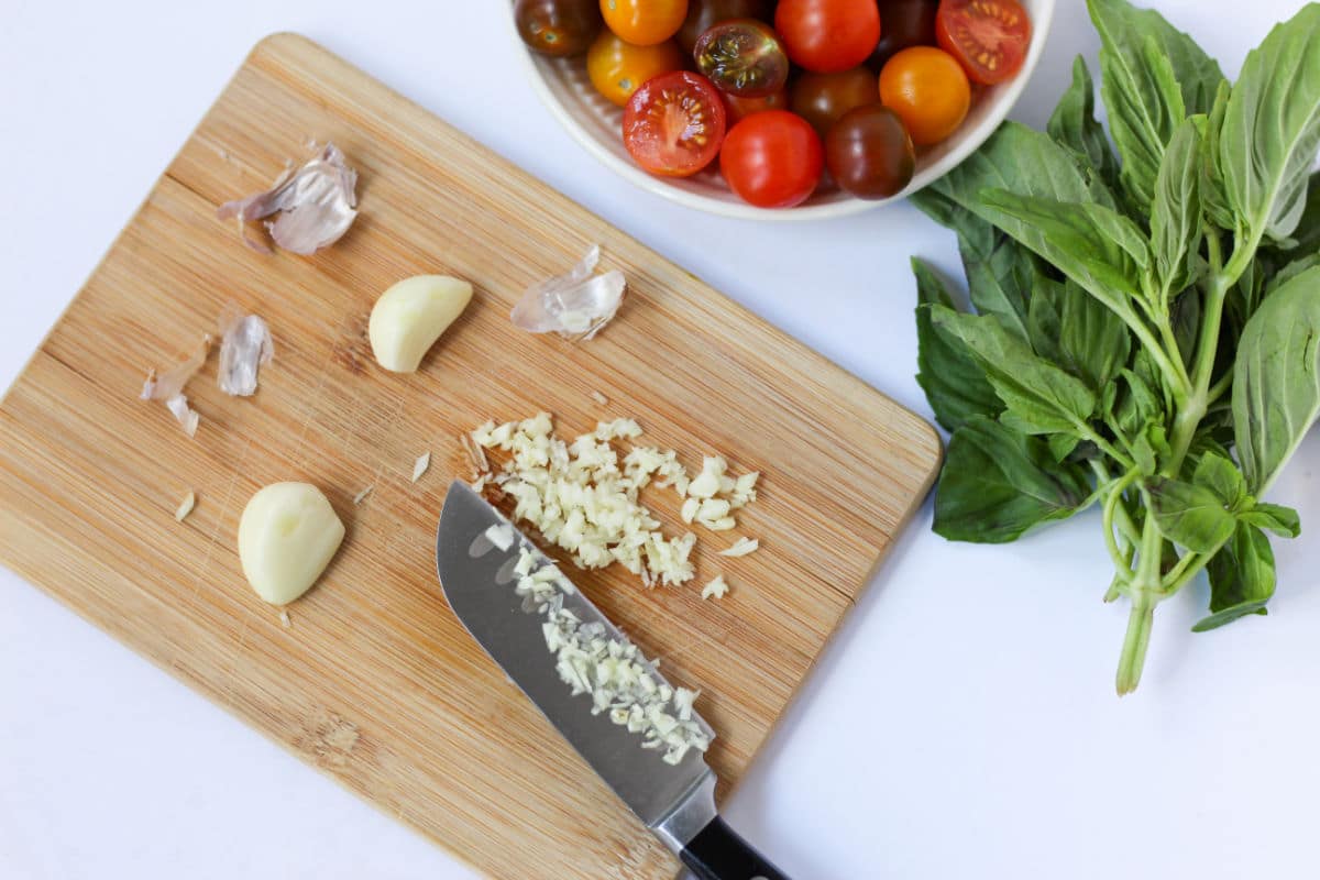 chopping garlic for linguine