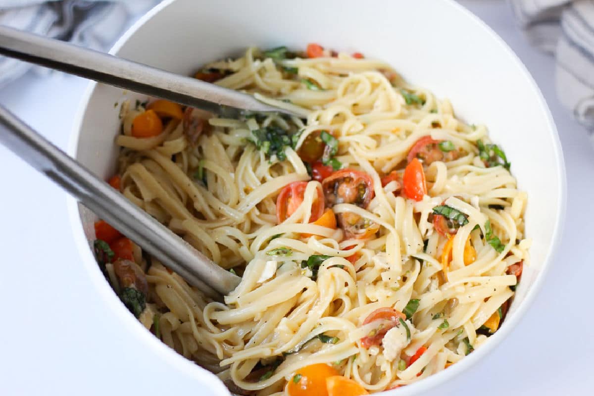 mixing linguine with brie cheese