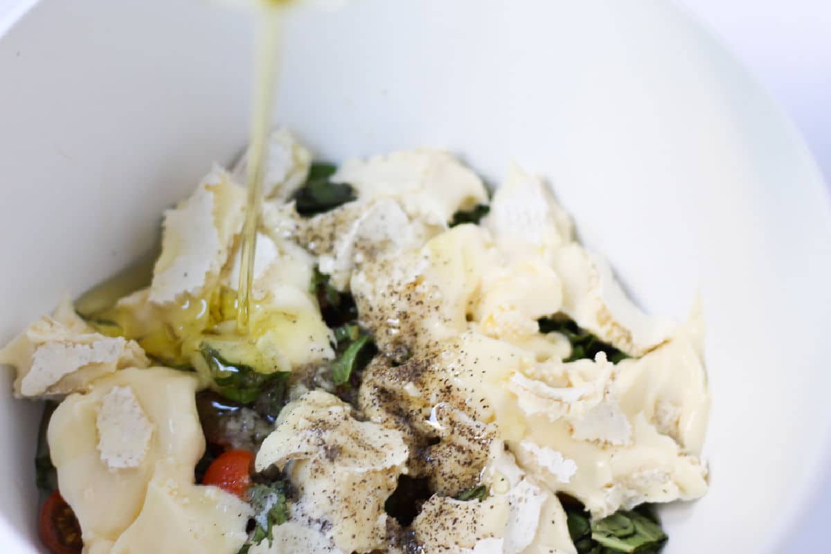 adding brie cheese to bowl