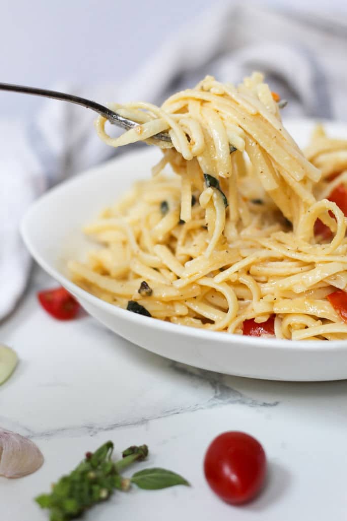linguine on fork in white plate