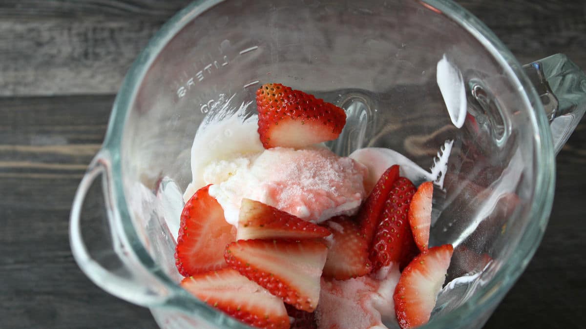 adding strawberries to cream