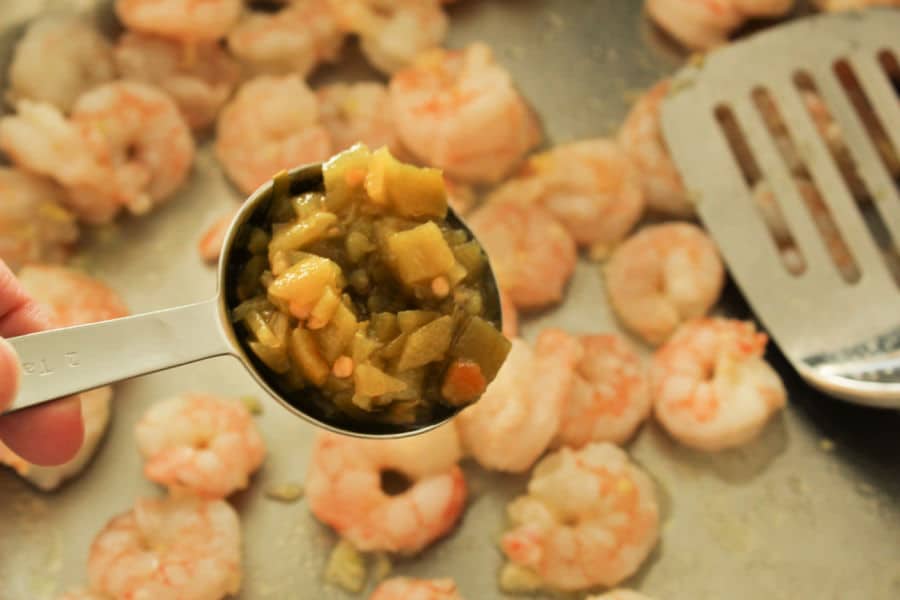 adding seasonings to shrimp