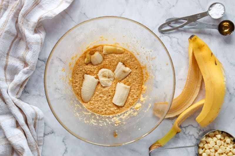 adding mashed bananas to sugar mixture