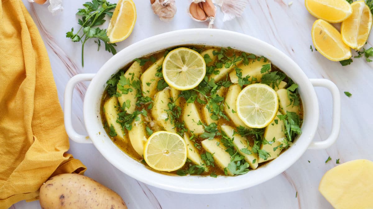 adding lemon and parsley to potatoes
