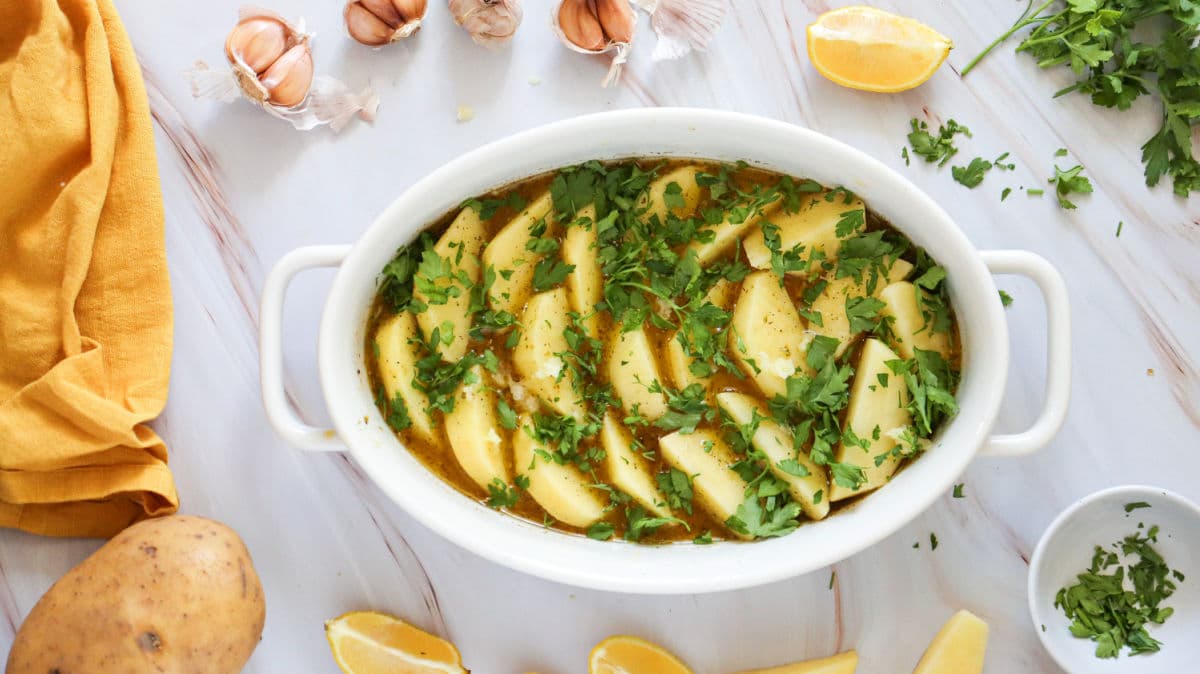 adding chopped parsley over potato wedges