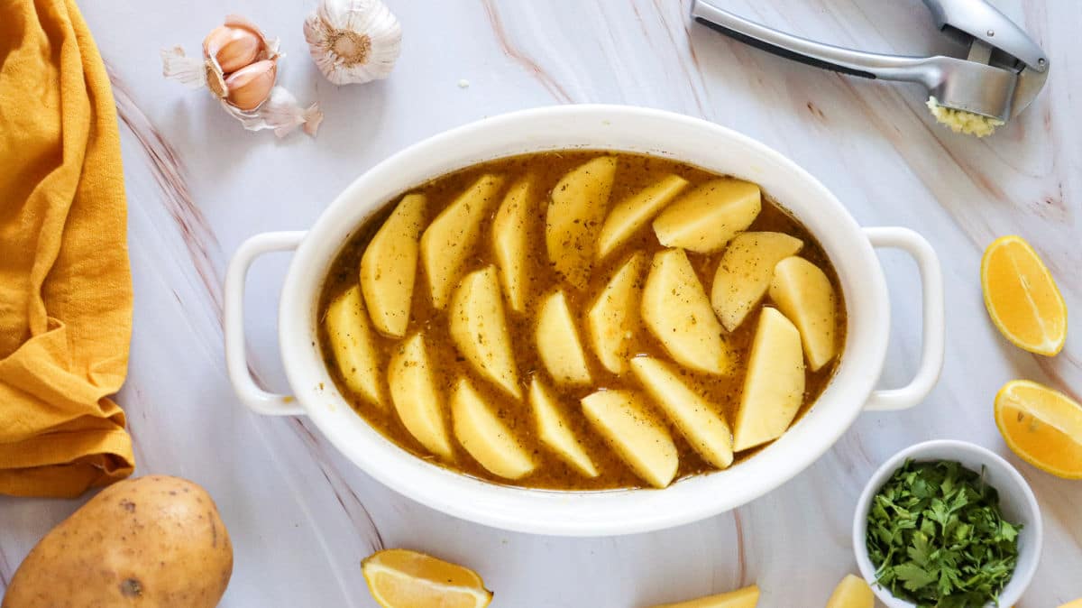 adding garlic over potato wedges