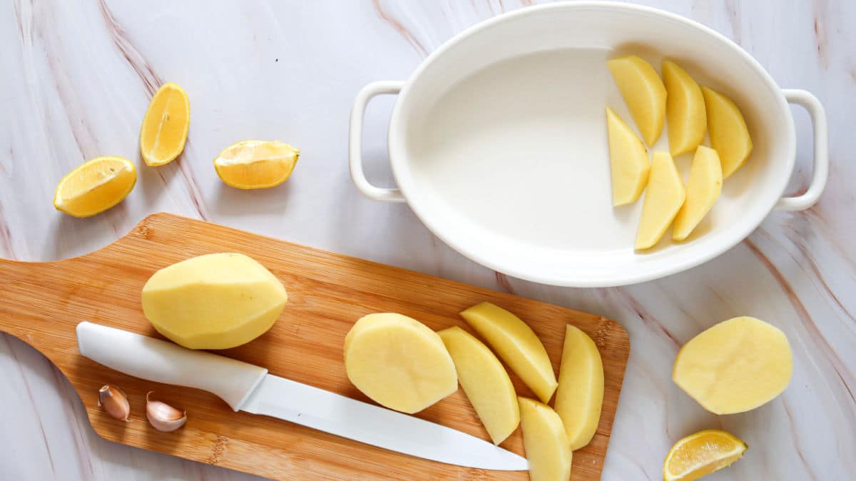 placing potato wedges in baking dish