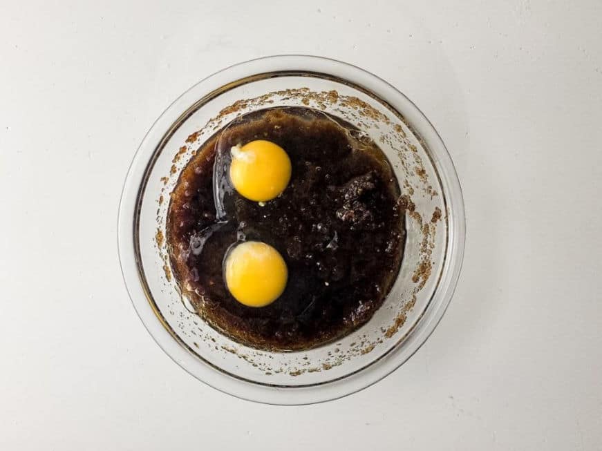 mixing eggs with dry ingredients for cookie bars