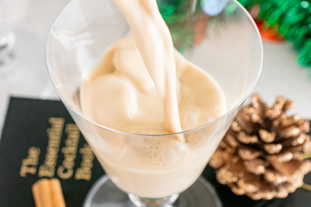 pouring espresso martini in martini glass