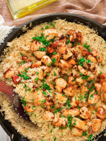 large skillet with creamy lemon chicken and rice