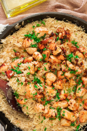 large skillet with creamy lemon chicken and rice