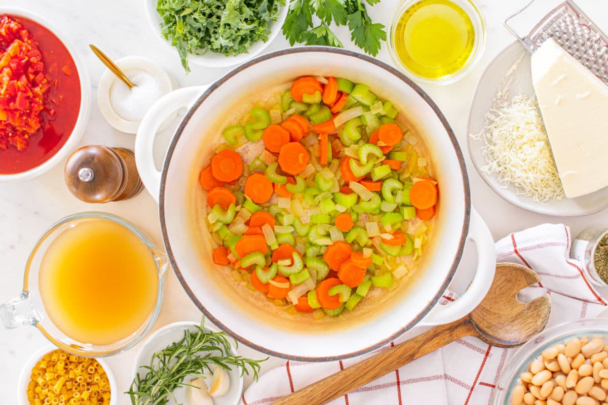 adding onions, carrots, and celery to the pot.