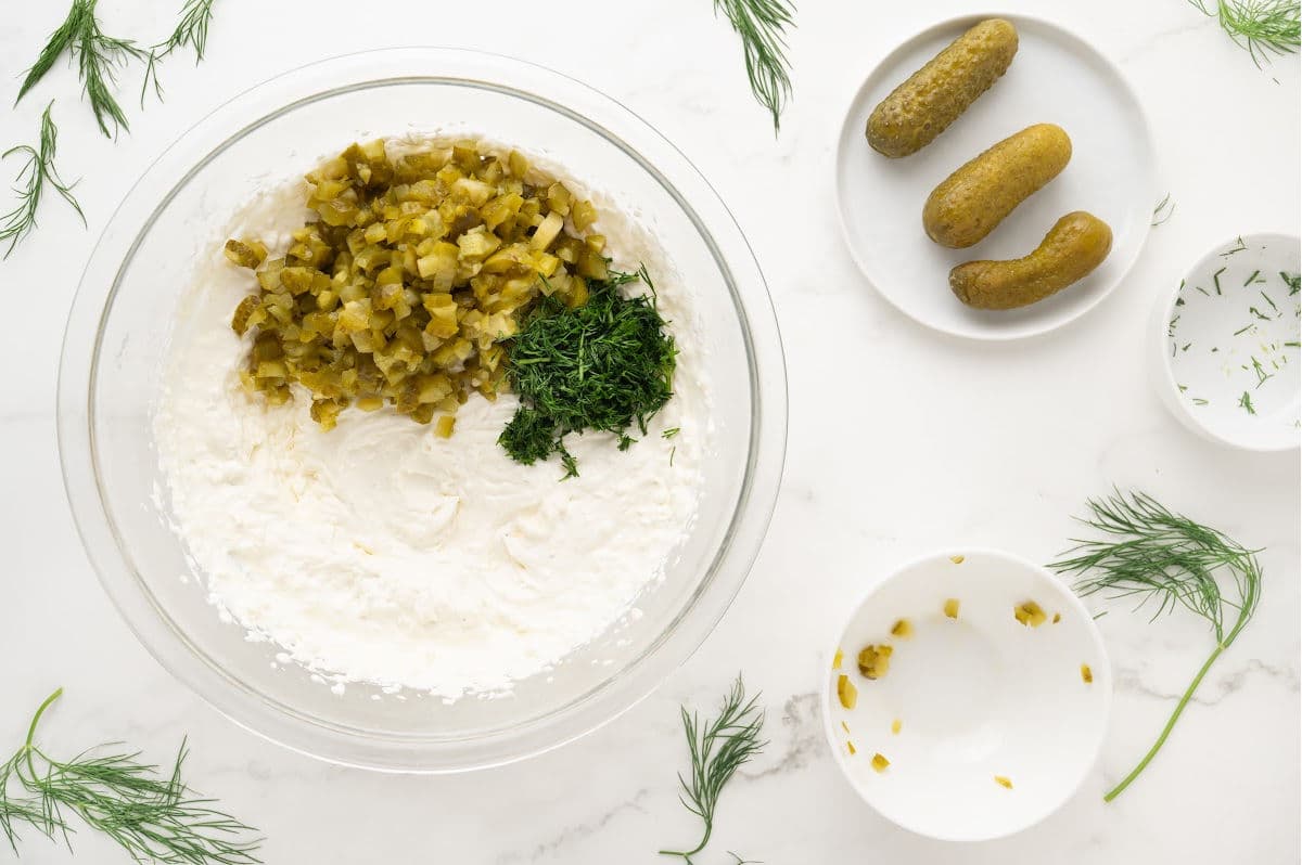 adding pickles, fresh dill, and pickle juice for dip.