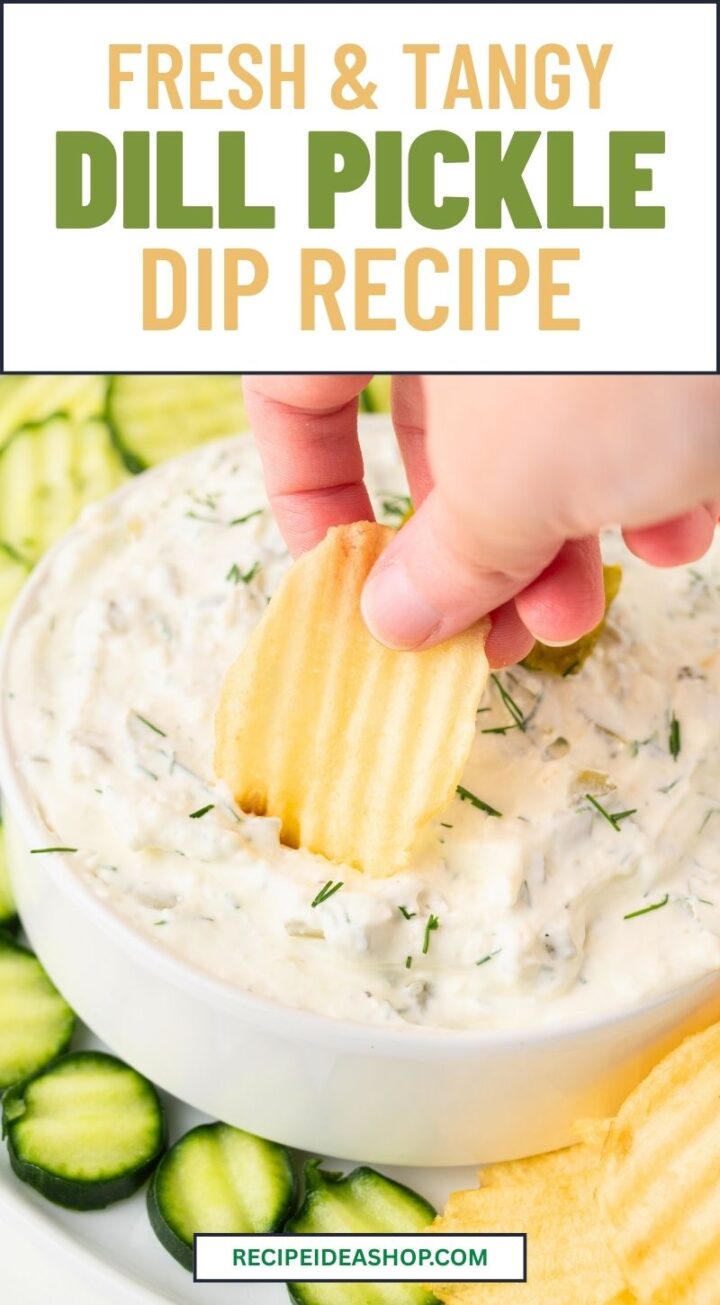 top view of dill pickle dip with hand dipping chip into dip