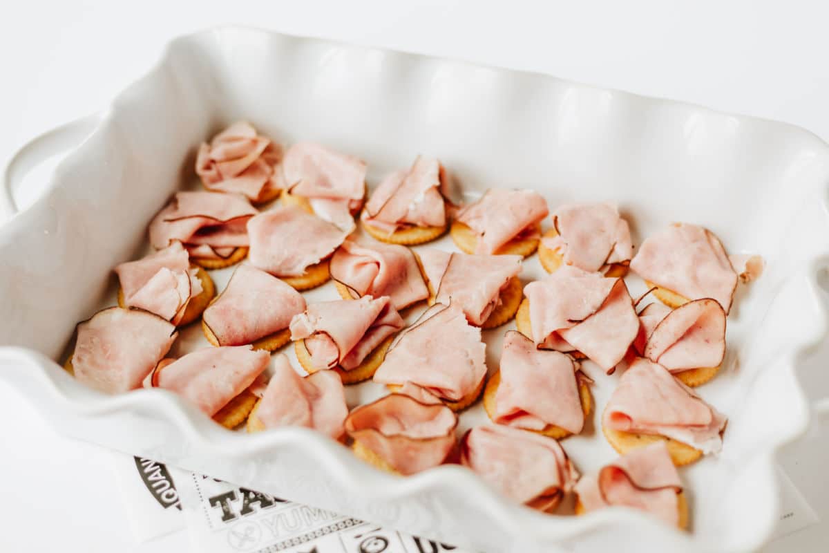 ham placed on top of ritz crackers