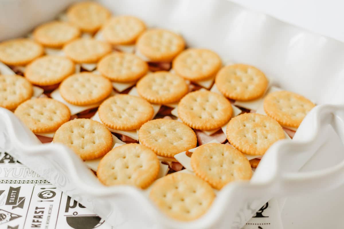 adding cracker on top of ham and cheese