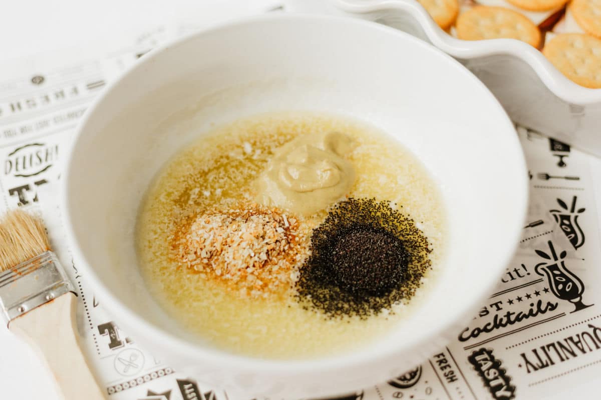 mixing melted butter, Dijon, Worcestershire, minced onion, and poppy seeds.