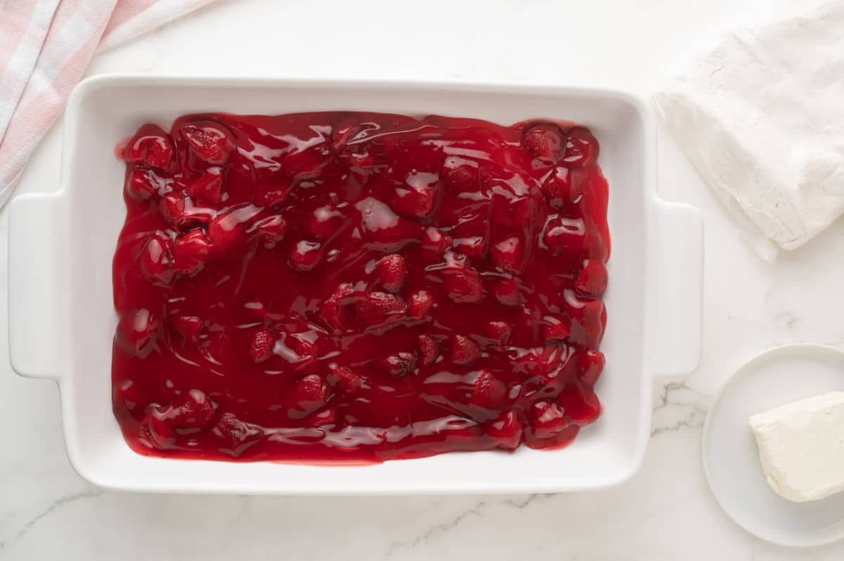 strawberry filling in the bottom of baking dish