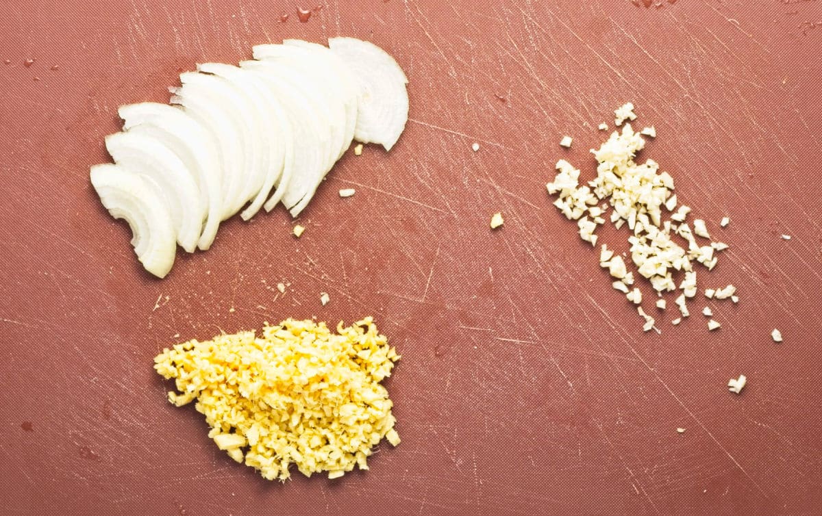 Sliced onions, minced ginger and garlic.