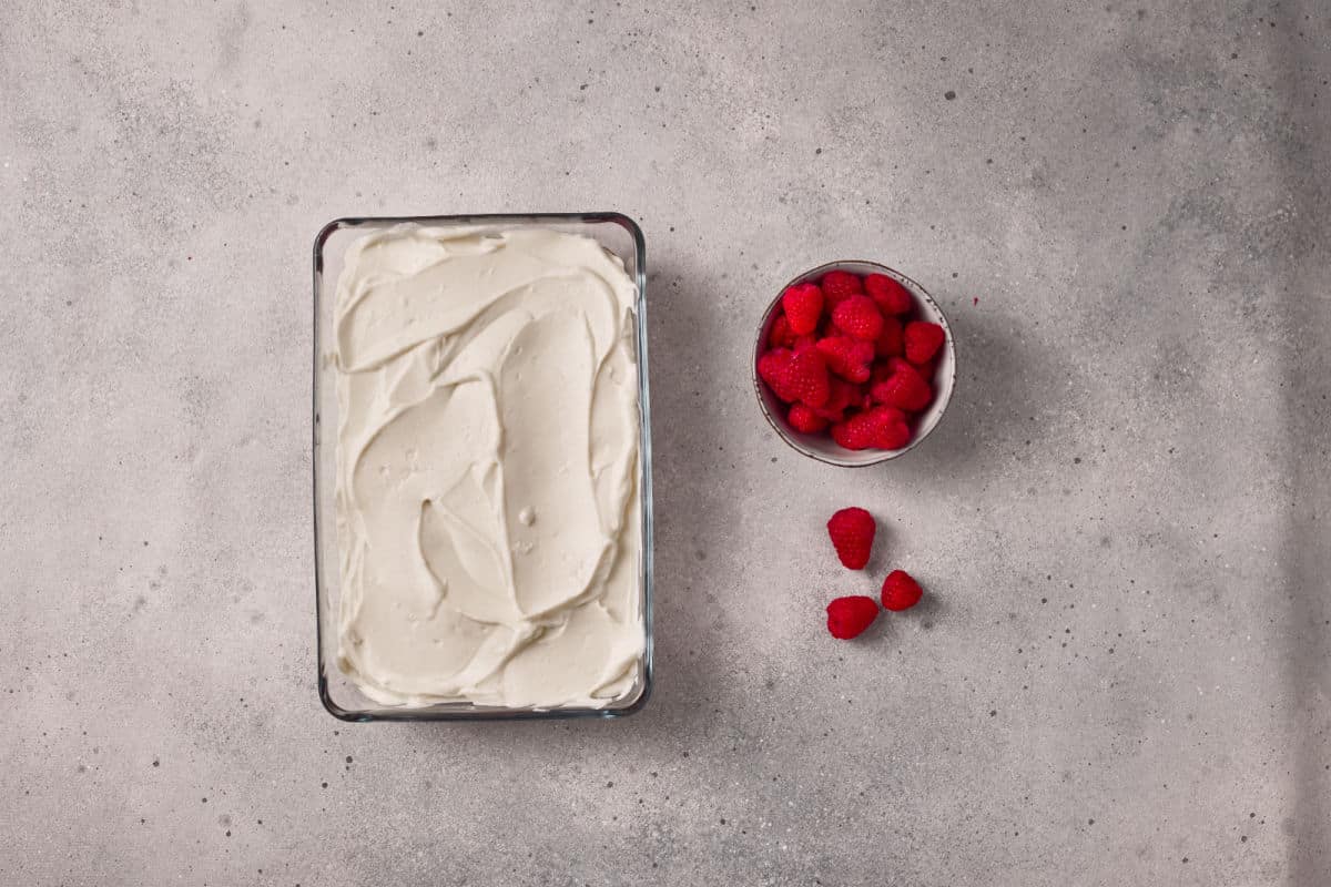 assembling tiramisu in glass baking dish