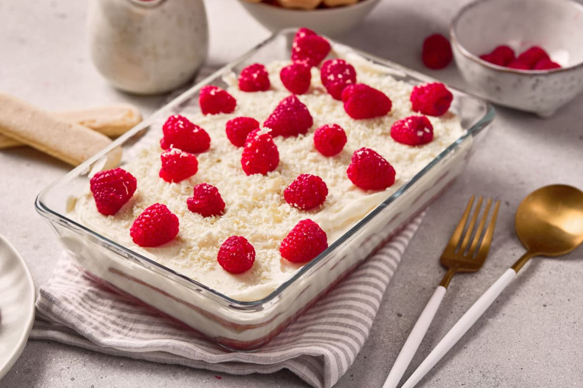 tiramisu topped wit shaved white chocolate and fresh raspberries
