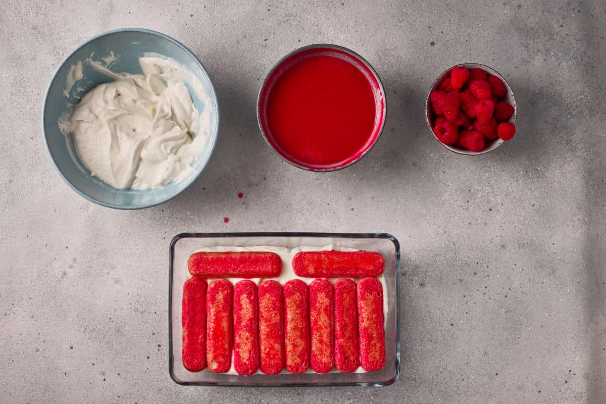 dipping ladyfingers in raspberry juice