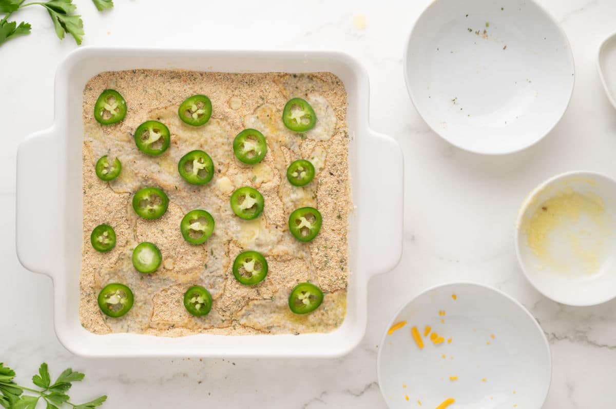 deseeding the jalapeno pepper and spreading on top of the butter and bread crumbs.
