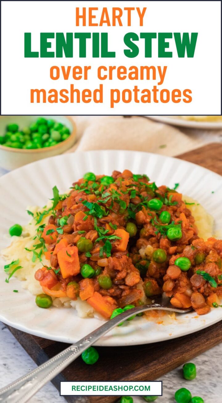 A plate of creamy mashed potatoes topped with savory lentil stew, carrots, and green peas, garnished with chopped parsley. In the background, a small bowl of green peas and a napkin are visible.