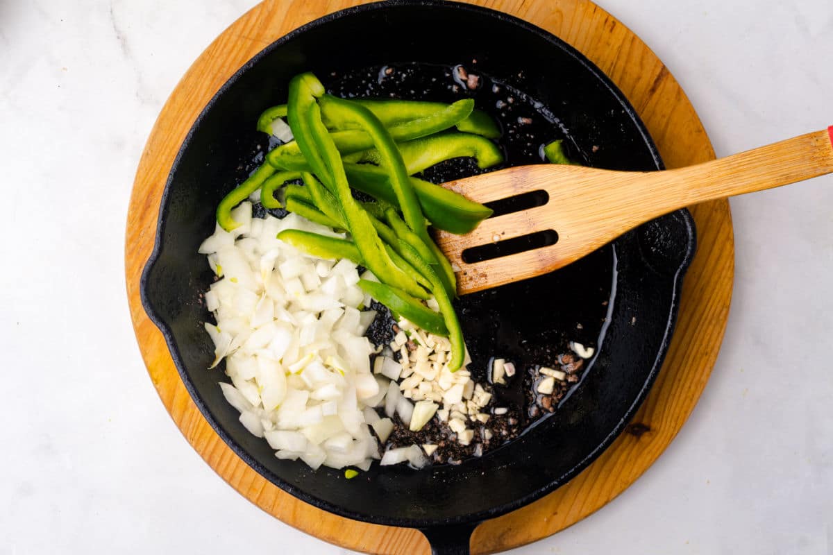 sliced onion and bell peppers Sautéing in skillet