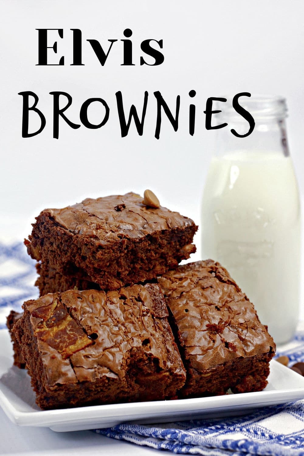 Chocolate brownies stacked on a white plate with a bottle of milk in the background. The text Elvis Brownies is written above the brownies.