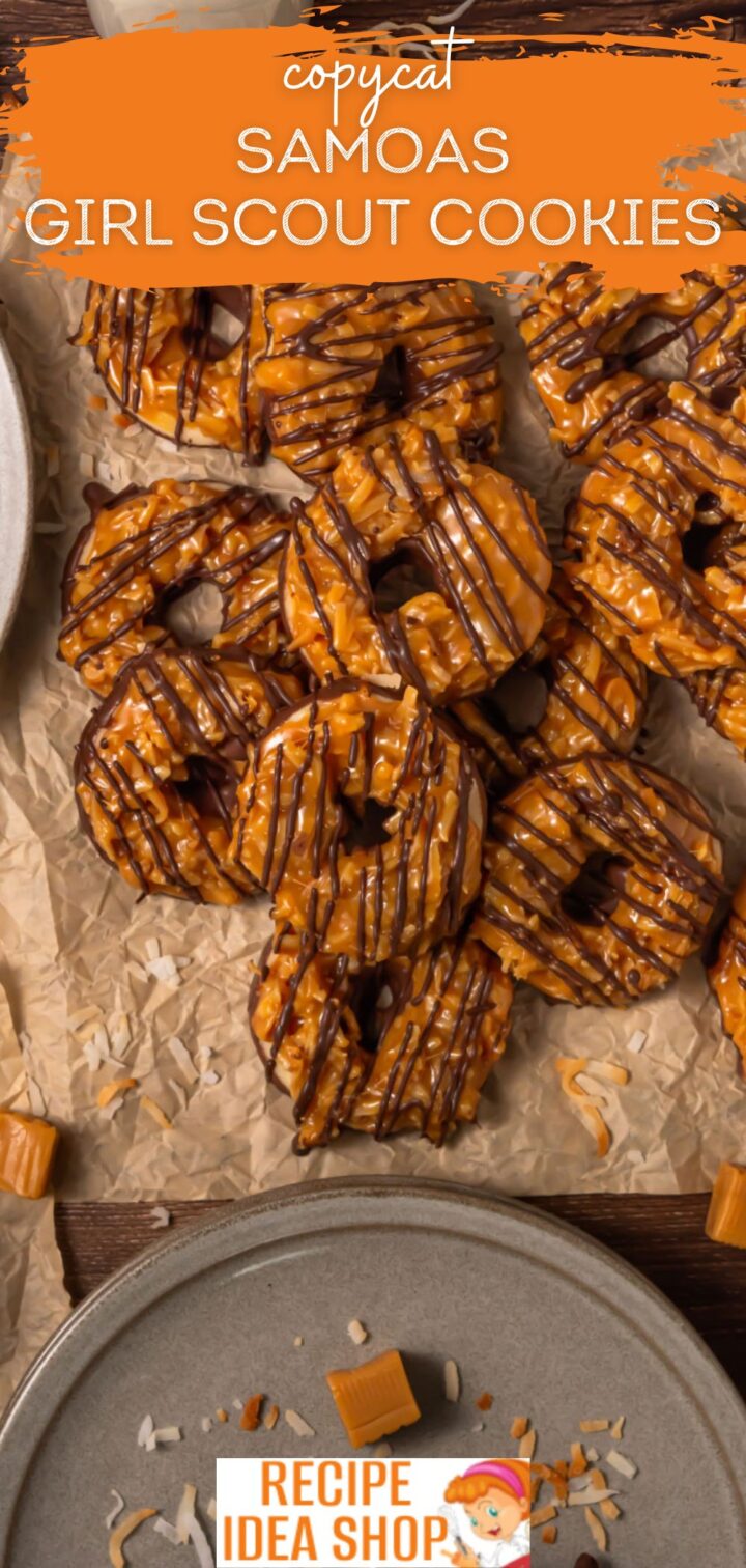 Overhead view of several homemade Samoa Copycat Cookies with caramel, coconut, and chocolate drizzle on parchment paper, surrounded by caramel pieces and toasted coconut.