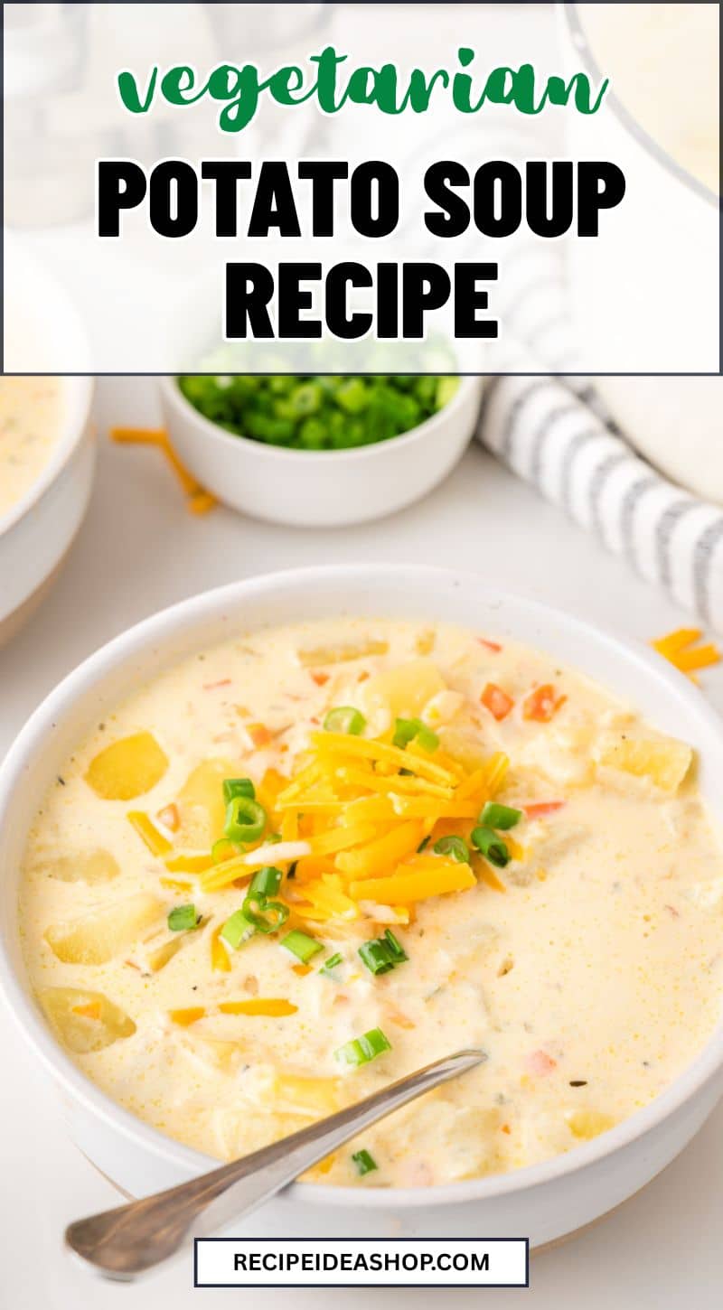 A bowl of creamy potato soup topped with shredded cheese and chopped green onions, with a spoon resting in the bowl. In the background are a bowl of chopped green onions and other soup bowls. Text overlay reads “Vegetarian Potato Soup Recipe.”.