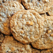 A close-up of several homemade oatmeal ice cream scoop cookies with visible oats and chocolate or butterscotch chips stacked together.